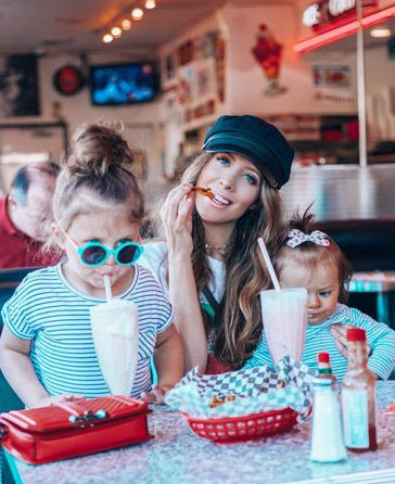 LaTisha enjoying milkshakes with her 2 daughters at a classic diner.