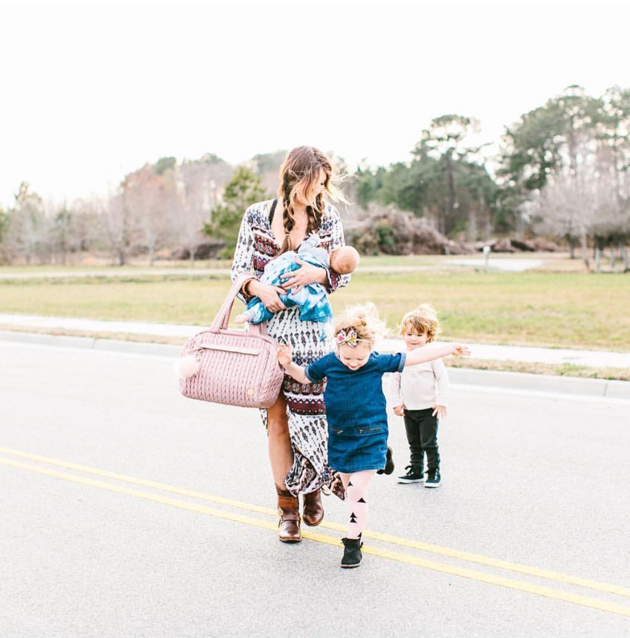 Briana takes a walk with her 3 children, modeling her HAPP Paige Carryall Dusty Rose and carrying her baby.