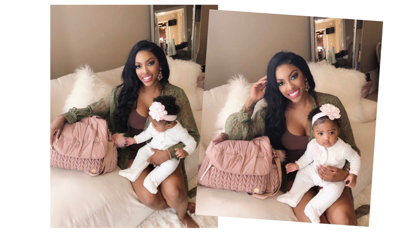 Real Housewives star Porsha Williams sitting on a daybed with her baby daughter and her Levy Backpack in Dusty Rose.