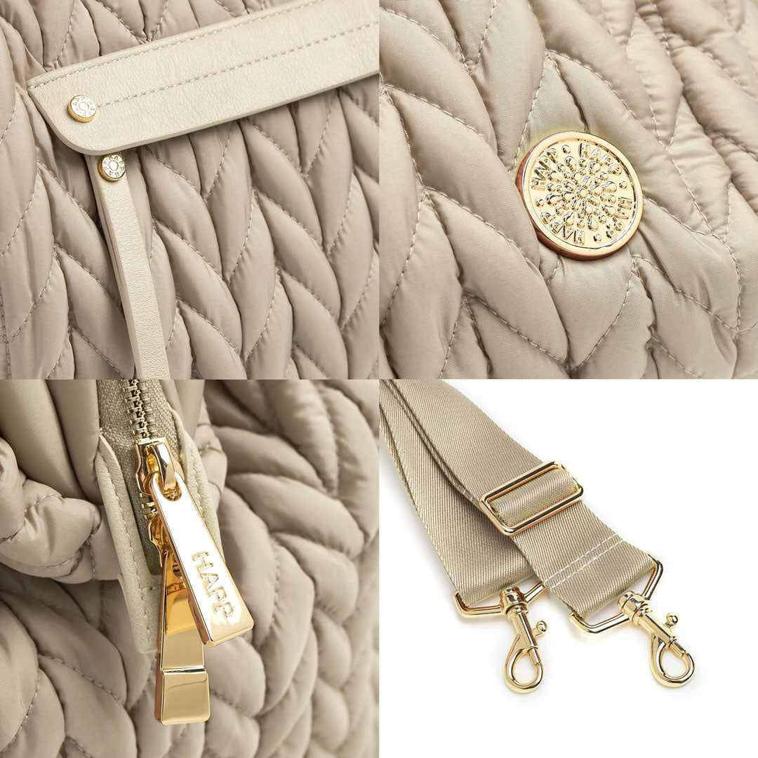 Details of the mommy pocket faux leather trim and zipper pull, gold logo and zipper hardware, and messenger strap.