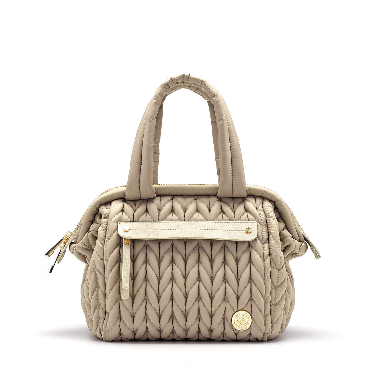 A structured mini purse-style diaper bag in beige, with a quilted design, featuring a wide top opening, a gold logo emblem, and a shoulder strap.