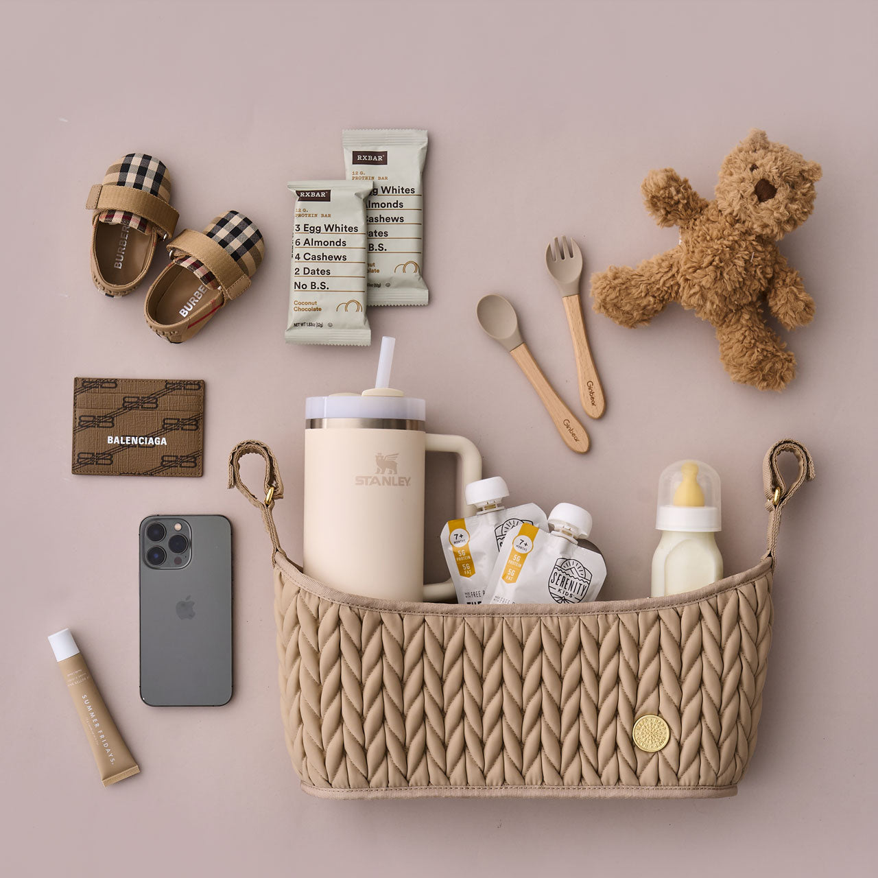 Beige stroller organizer shown packed with matching mom and baby items.