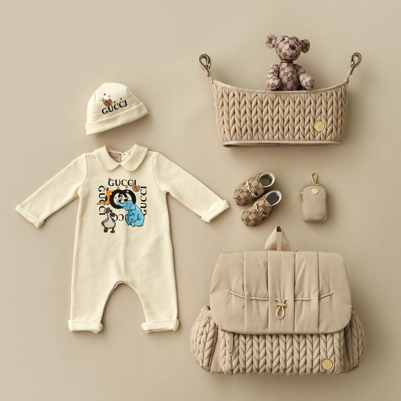 Flat lay with HAPP Stroller Organizer, Levy Backpack, and Clip-on Pouch all in matching Beige, arranged with matching mom and baby items.