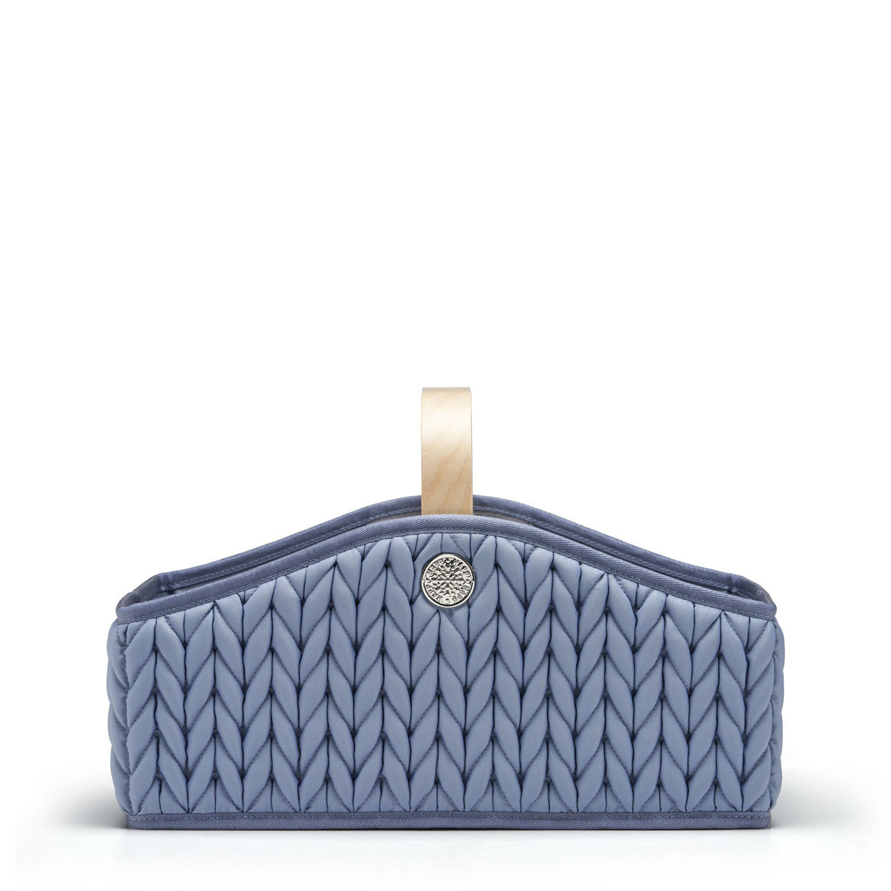 Blue diaper caddy with wooden handle, sleek curved sides, 3D quilted herringbone texture, and gold hardware details, shown straight on from the side.