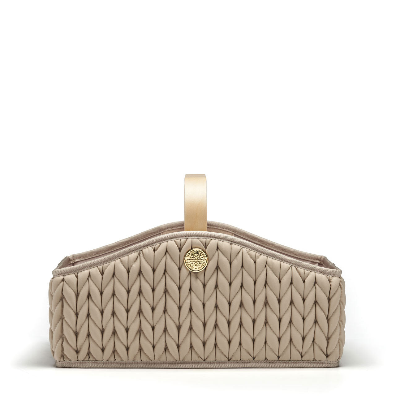 Beige diaper caddy with wooden handle, sleek curved sides, 3D quilted herringbone texture, and gold hardware details, shown straight on from the side.