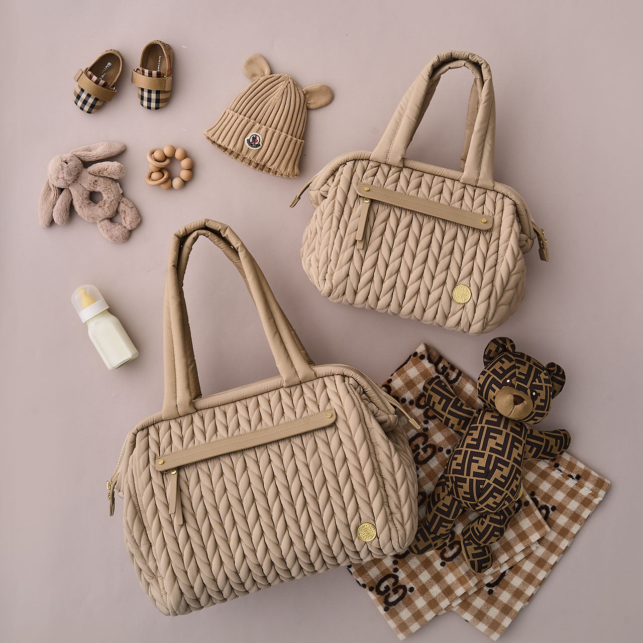 Paige Mini Beige purse style diaper bag next to the larger Paige Carryall version.
