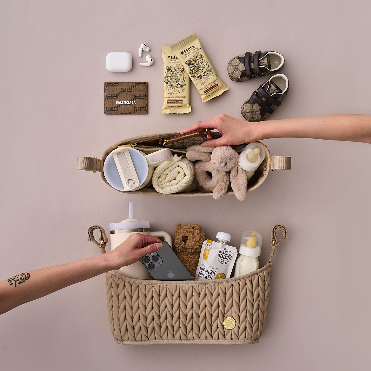 Fully packed Stroller Organizers in Beige shown from two angles, front and above, with two hands taking one item out of each. Shows the structure and packing capacity of the caddy.