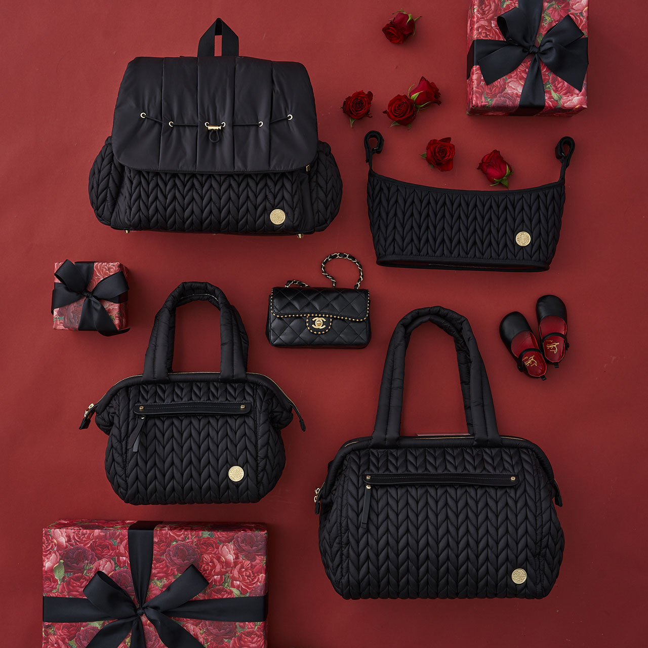 HAPP Brand Black collection of products shown all together, including Levy Backpack, Paige Carryall, Paige Mini, and Stroller Organizer.