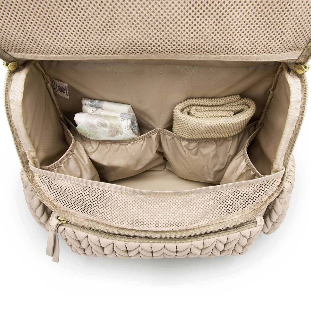 Levy Backpack Beige shown open from the top down to show the spacious main compartment and 4 interior pockets for easy organization. Bag is lined with beige fabric.