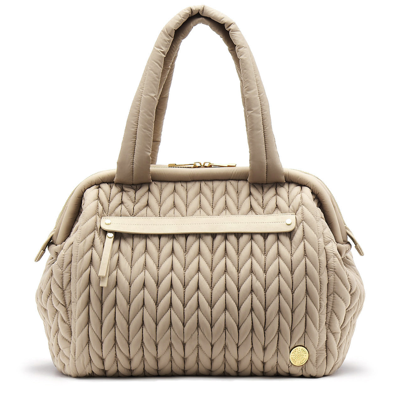 A beige structured diaper bag with a quilted design, featuring a wide top opening, external pockets, and a branded gold accent.