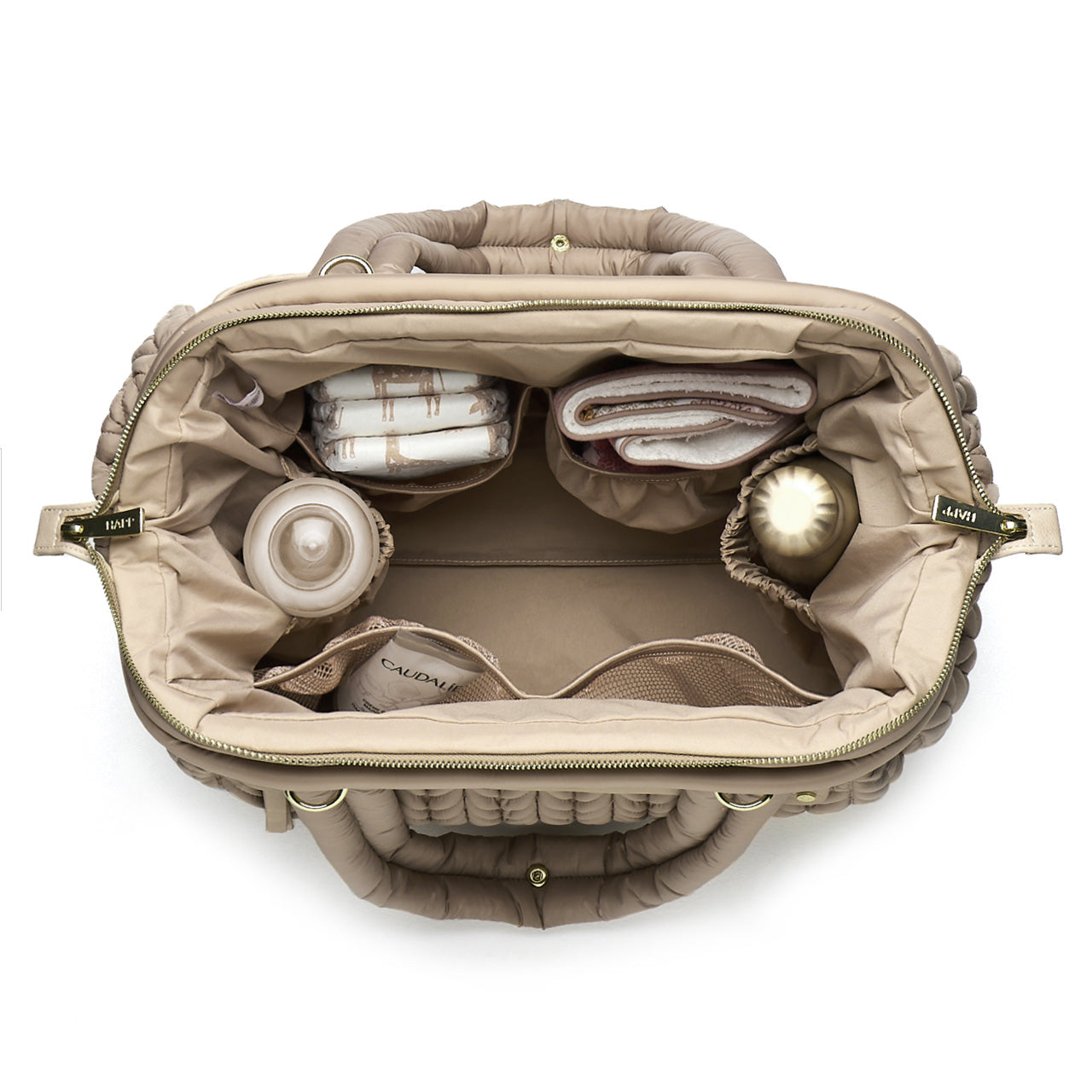 Paige Carryall Beige from above, open and partially packed, showing the wide Mary Poppins opening and the view into every corner of the bag.