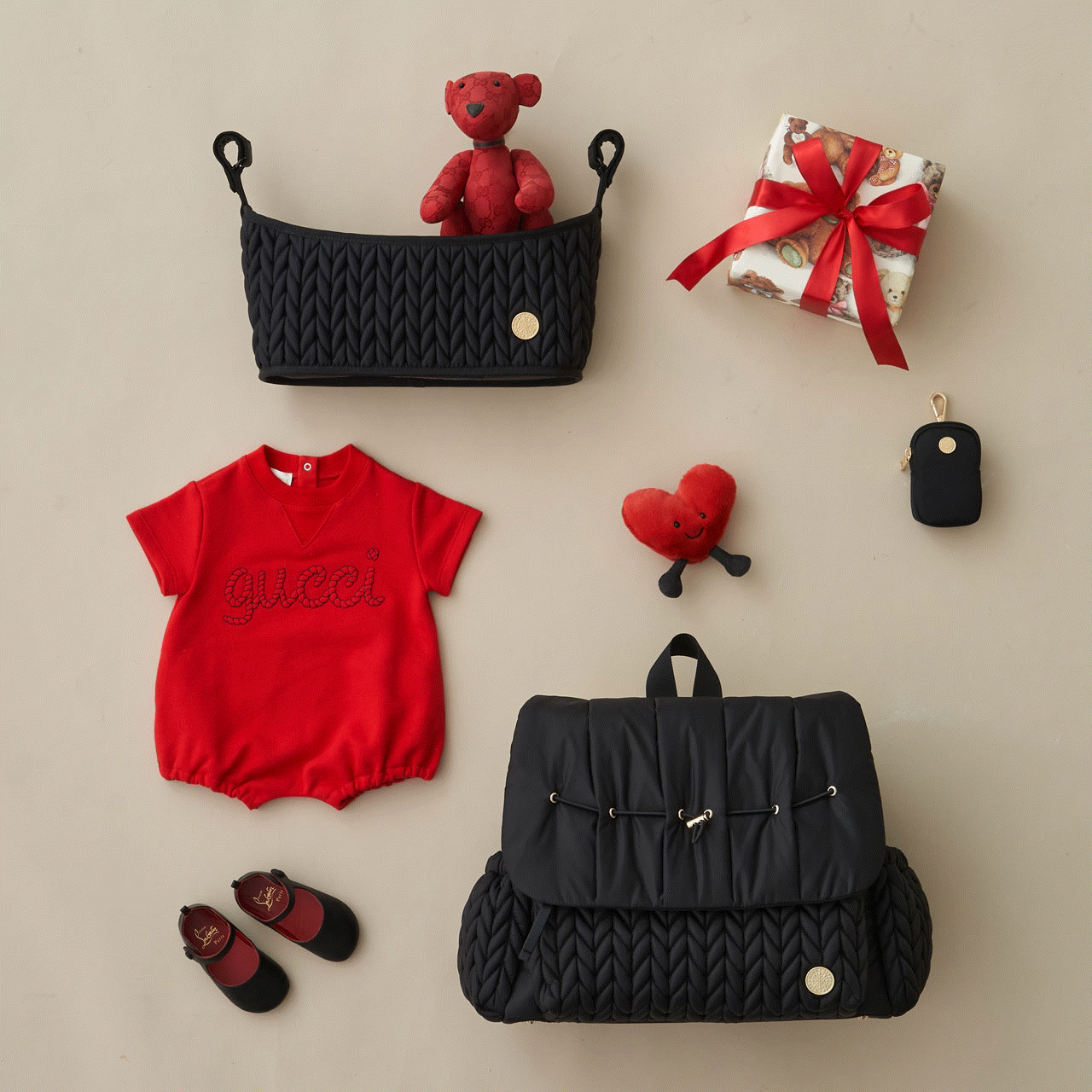 Moving GIF with Levy Backpack Black and Stroller Organizer Black arranged with Clip-on Pouch Black and red baby items. The Levy is opening and closing to show the wide opening and impeccable organization of HAPP diaper bags.