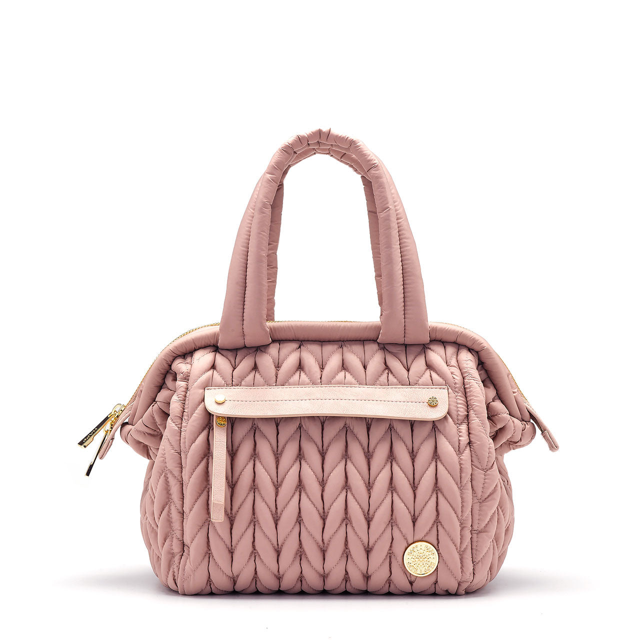 A dusty rose colored mini diaper bag with a structured frame and a 'Mary Poppins' style top opening.