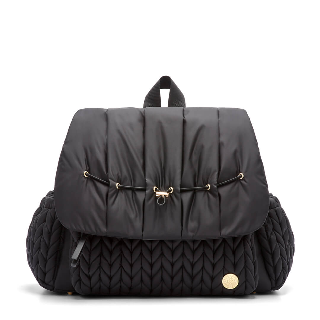 A black Levy backpack with a wide zippered flap and wide straps, featuring a quilted pattern on the front compartment and a gold logo emblem.