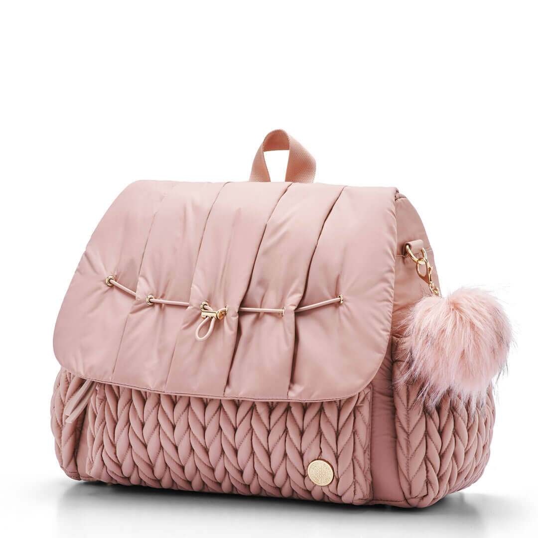 Rose faux fur pouf clipped onto the side of the Levy Backpack in Dusty Rose.