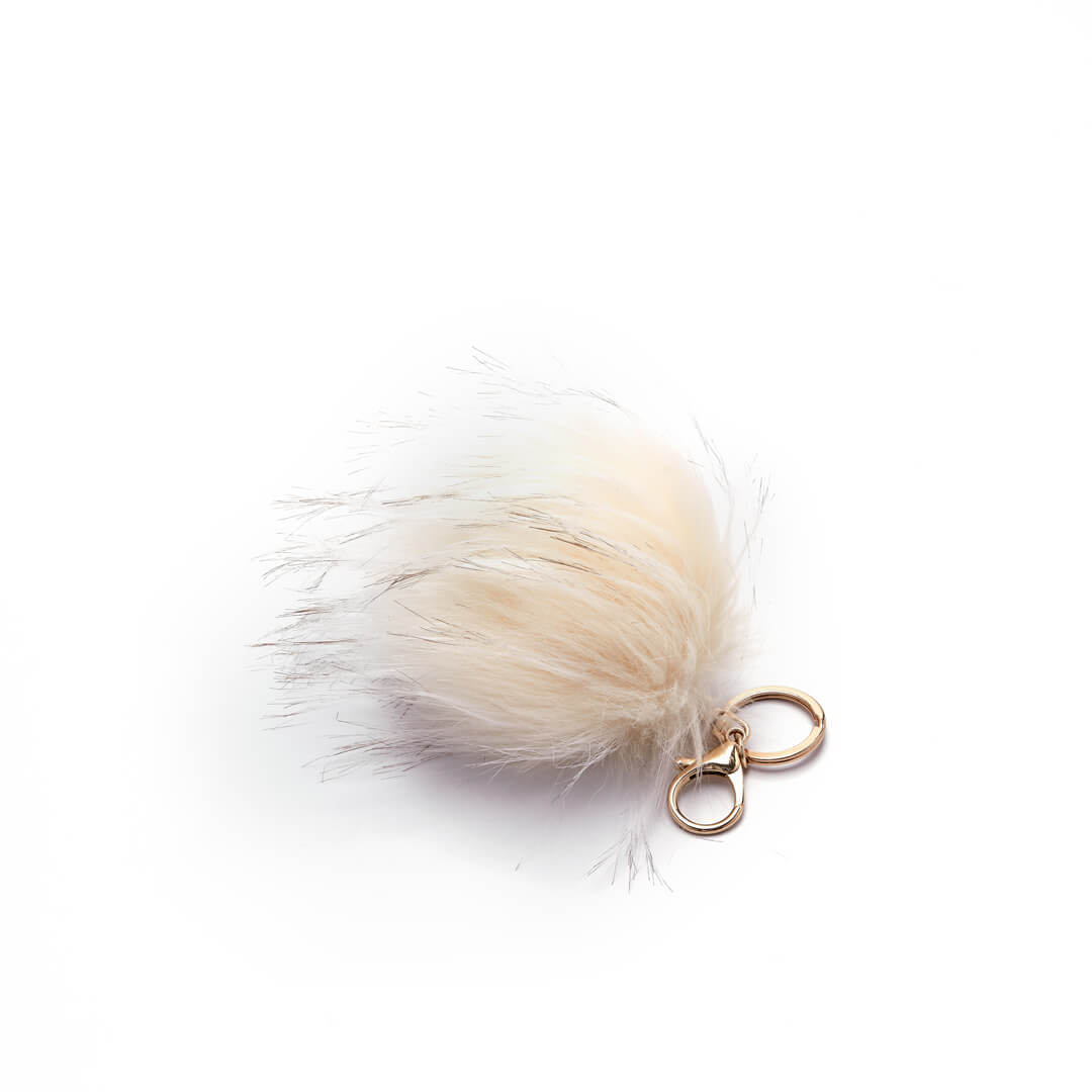 Faux fur pouf keychain in ivory with key ring and clip attachments.
