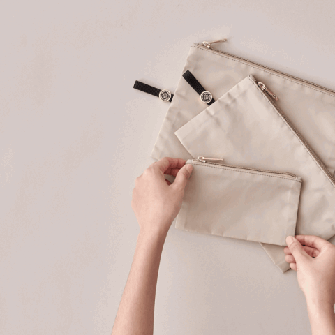 Moving gif of 3 beige packing pouches, demonstrating the expandable gusset bottoms of the 3 sizes of pouch.