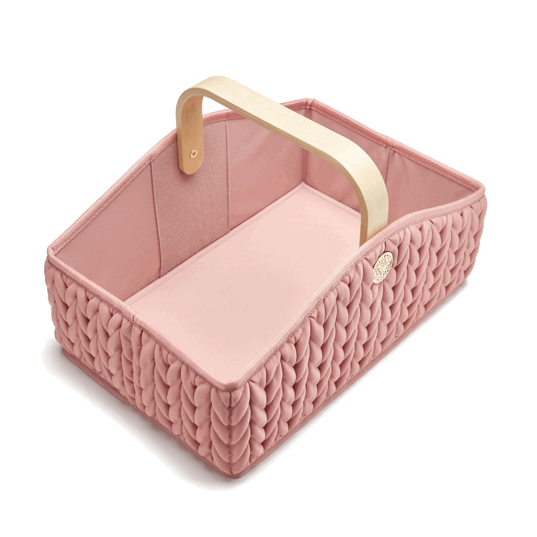 Moving GIF of rose diaper caddy, 3/4 angle from above, showing inside of the caddy with and without the removable divider pockets.