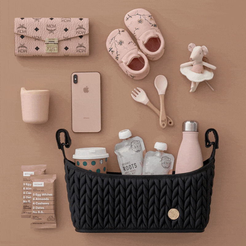 Moving GIF of the Stroller Organizer Black shown with pink, beige, and blue backgrounds, each packed and arranged with matching mom and baby items according to each background color.