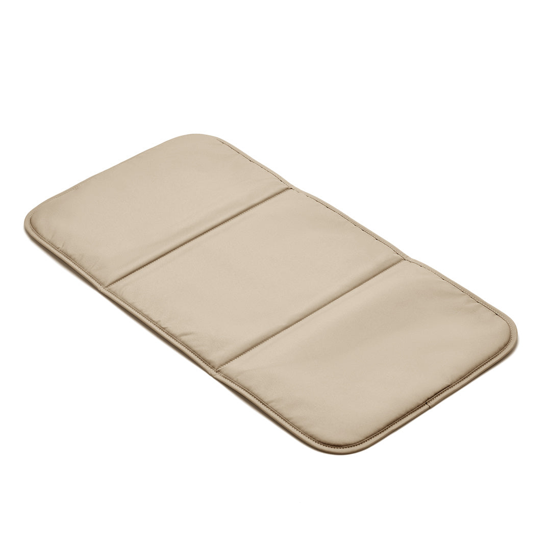 Beige memory foam changing pad, unfolded and lying flat.