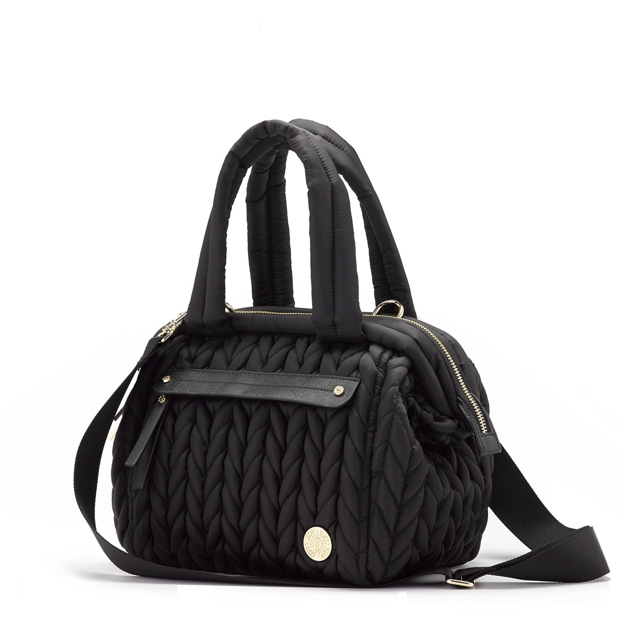 Three-quarters view of Paige Mini Black, showing front mommy pocket, carry handles, messenger strap, and gold hardware details.