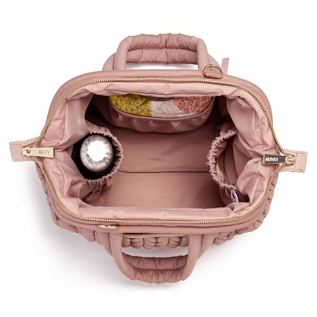 Top-down view of the Paige Mini Dusty Rose's Mary Poppins style opening, packed with baby items.