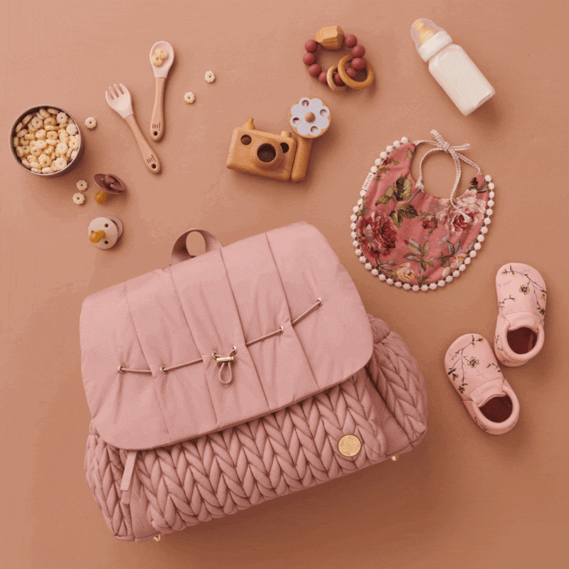 Moving GIF of the Levy Backpack Dusty Rose lying flat, with the top flap opening and closing to show the wide-open view and impeccable interior organization of HAPP diaper bags.