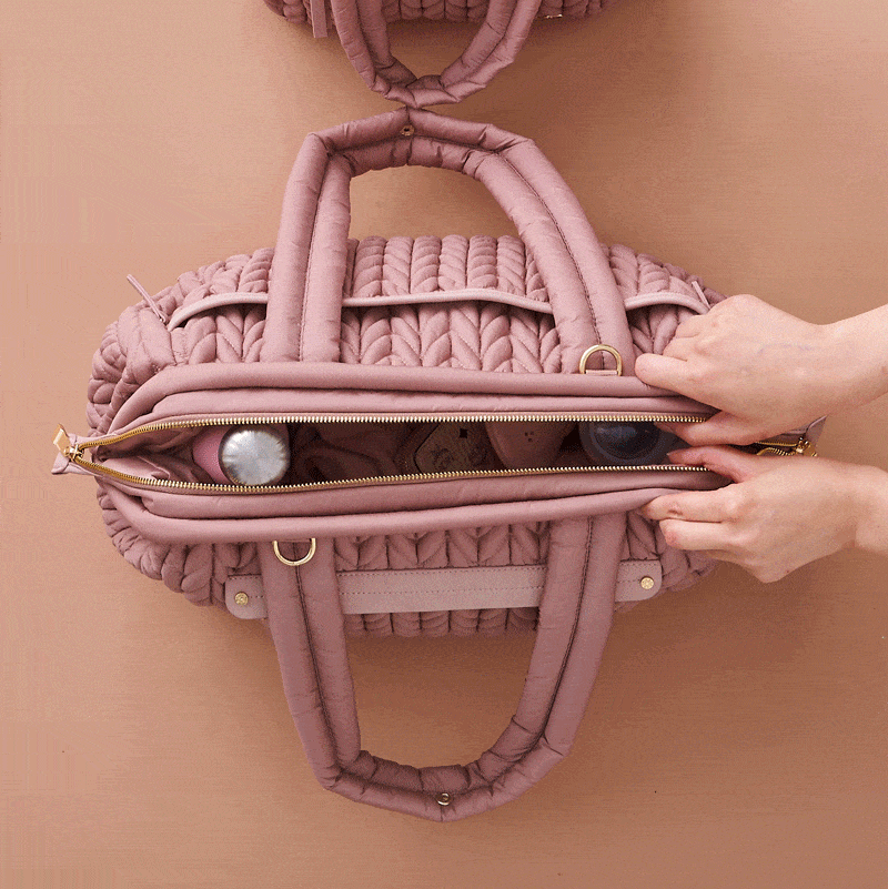 Moving GIF of two hands opening and closing a fully-packed Paige Carryall Rose, showing the wide Mary Poppins style opening.