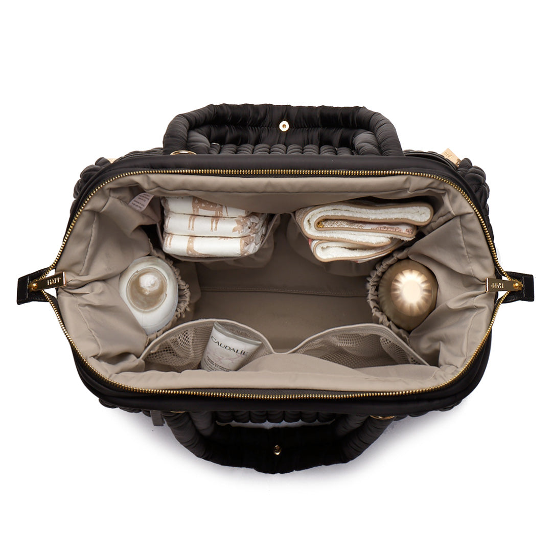 Paige Carryall Black from above, open and partially packed, showing the wide Mary Poppins opening and the view into every corner of the bag.