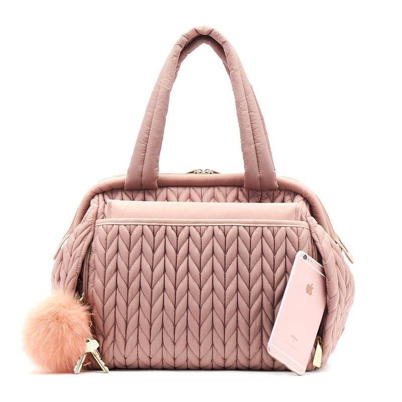 Paige Carryall purse handbag style diaper bag with quilted herringbone nylon in dusty rose blush pink with gold hardware with pink pouf keychain