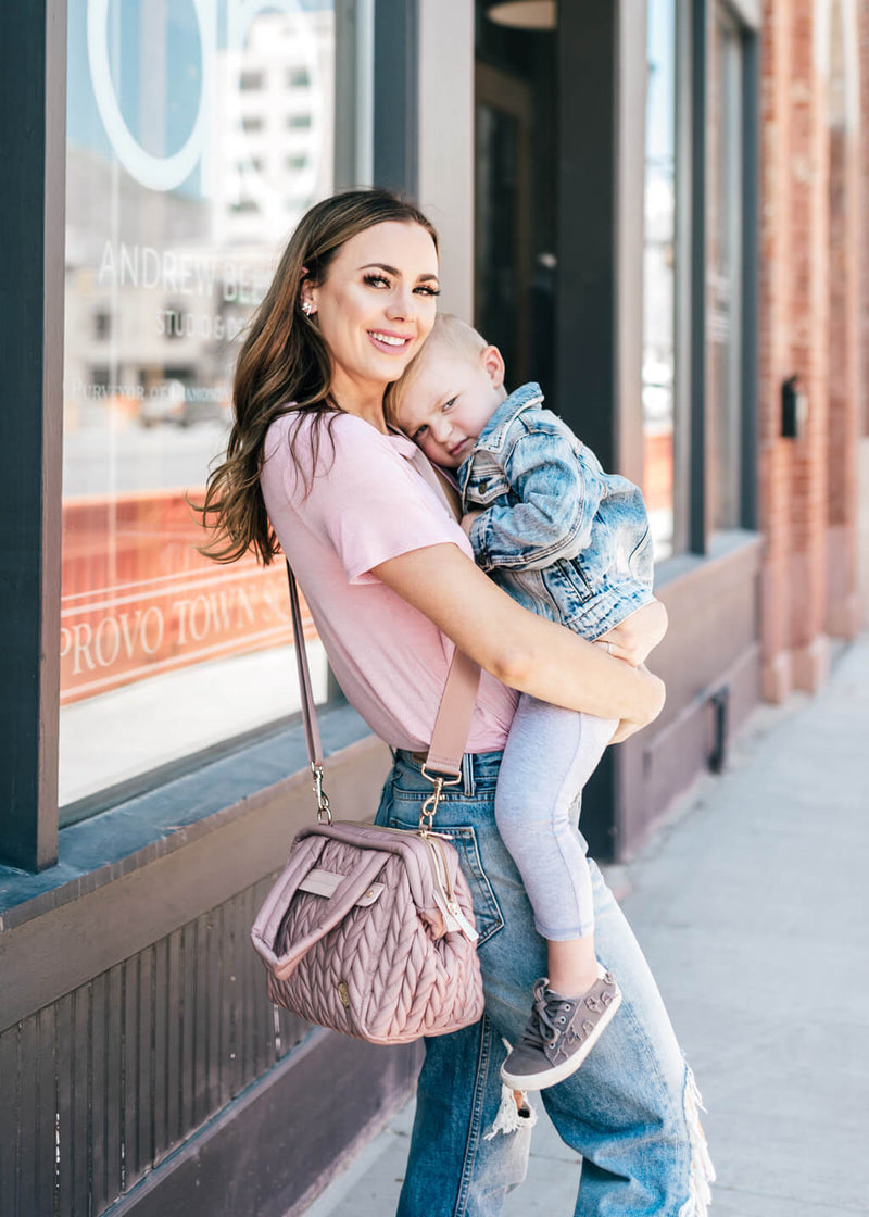 Paige mini purse style diaper bag in dusty rose on body